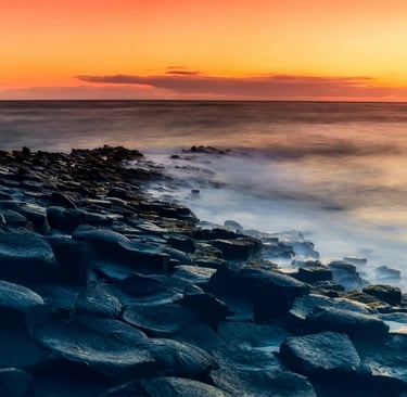 a sunset over the ocean with a view of the ocean