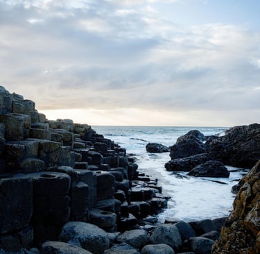 a rocky beach with a view of the ocean