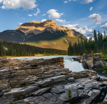 a mountain scene with a waterfall