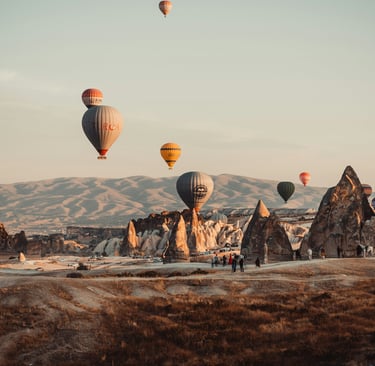 turkey balloons flying over a mountain