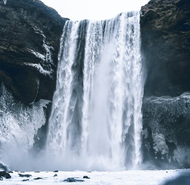 a waterfall in the middle of a mountain