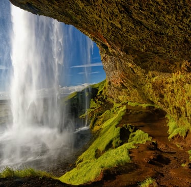 a waterfall in the middle of a cliff