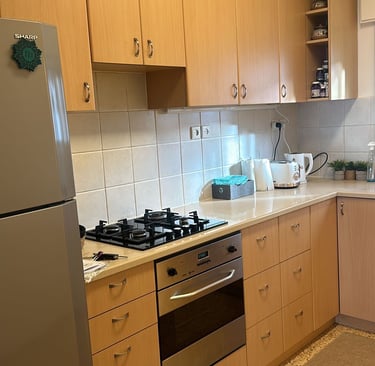 a kitchen with a stove top oven and a refrigerator