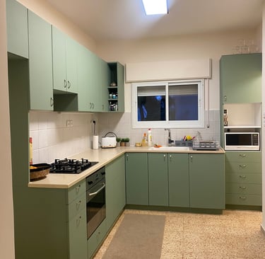 a kitchen with a green kitchen with a white counter top