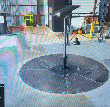 A solar panel street light undergoing high-velocity wind tunnel testing at the FIU Wall of Wind facility.