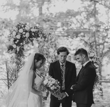 Caleb Postlewait leading prayer for Matt and Kyle Kloet's wedding ceremony