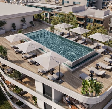 Luxury rooftop pool area with sunbeds and umbrellas at Lev Limassol, Cyprus