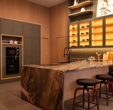 a kitchen with a marble counter top and bar stools