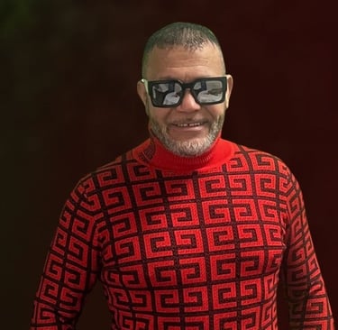 Independent artist Leo Glasson wearing sunglasses and a red patterned sweater.