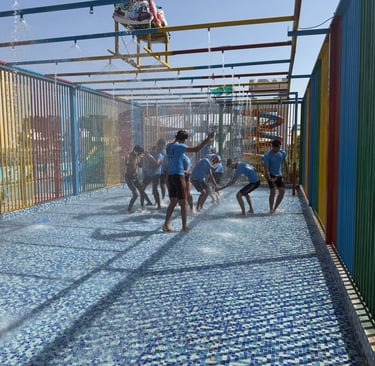 a group of people playing with water in a playground