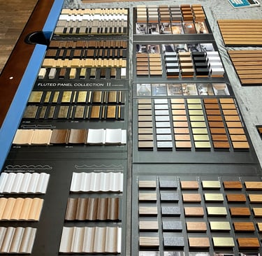 A variety of interior fluted wall panel samples in wood, metallic, solid colours for home design.