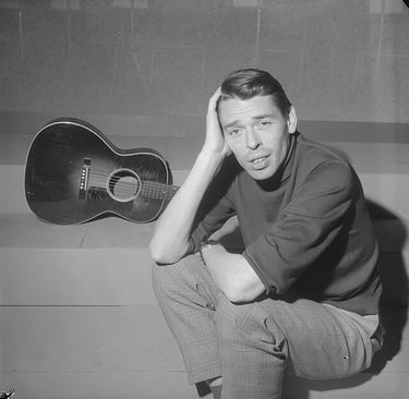 jacques brel in posa con la sua chitarra