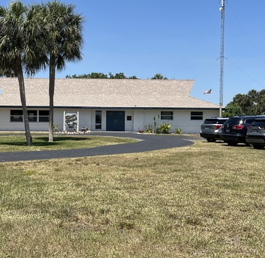 a clubhouse with cars parked in front of a clubhouse