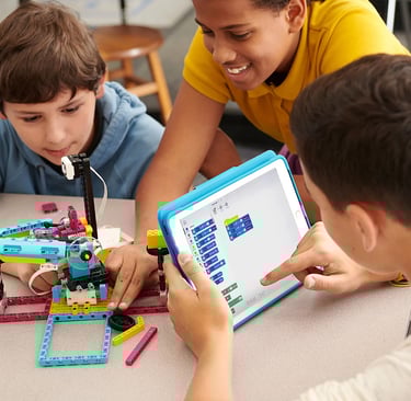 Teenagers working together to build and code a complex, multi-functional robot.