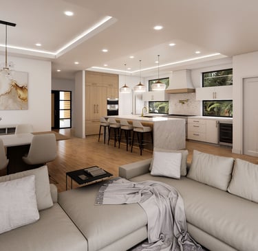 Modern open-concept interior featuring a marble kitchen island, neutral sectional sofa, and recessed tray ceiling.