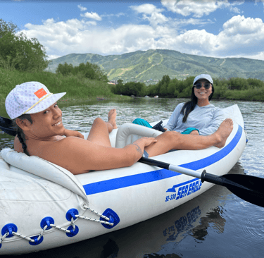 A beautiful couple rafting in a cool mountain lake in the Colorado Rockies!