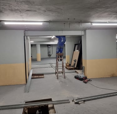 a man working in a commercial space with a ladder