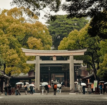 Massive wooden torii gate entrance to Meiji Shrine surrounded by forest in Tokyo