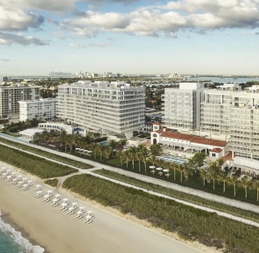 Four Seasons Surf Club historic 1930s building exterior with palm tree-lined entrance and Mediterran