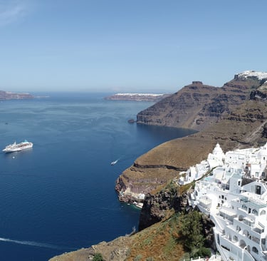 White architecture and luxury resorts overlooking the Aegean Sea in Santorini, Greece.
