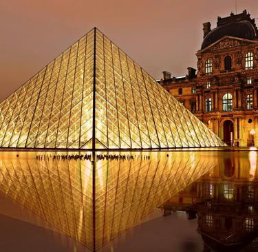Louvre Museum glass pyramid and palace in Paris France