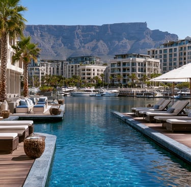 Luxury resort pool at V&A Waterfront in Cape Town with views of Table Mountain and harbor yachts.