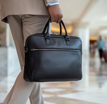 Business traveler carrying premium laptop bag through airport terminal