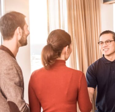 a group of people standing around a mirror