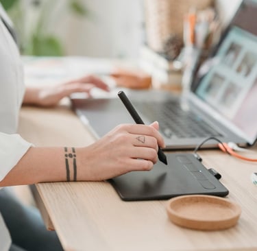 a woman sitting at a desk with a pen and a pen