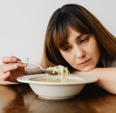 Photo By: Kaboompics.com: https://www.pexels.com/photo/close-up-of-a-sad-woman-eating-soup-