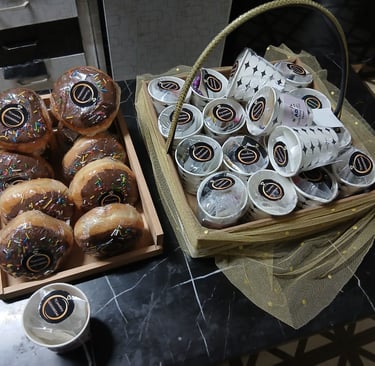 a basket of donuts and coffee cups