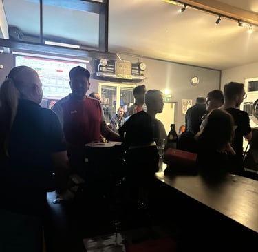 a group of people standing around a bar