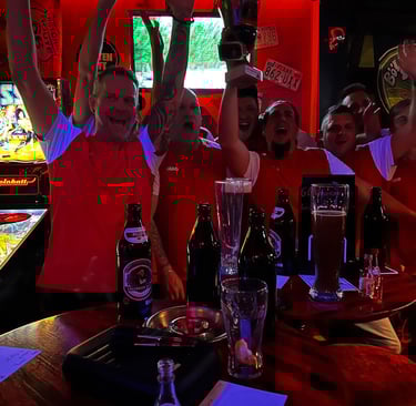 a group of people standing around a bar