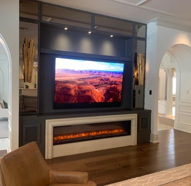 living room with a television and a fireplace