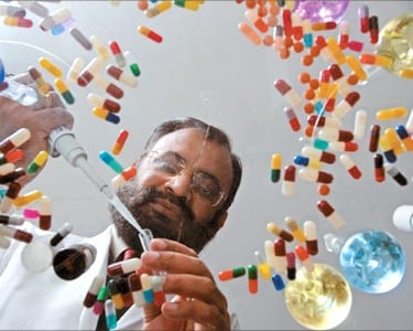 a man with a beard and glasses is holding a pair of scissors and scissors