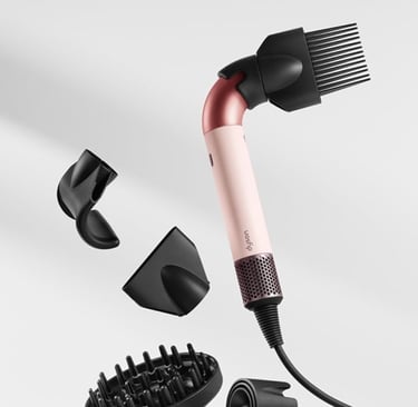 a hair dryer with a brush and a comb