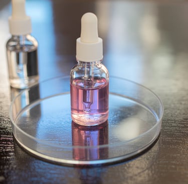 a small bottle of liquid in a glass plate