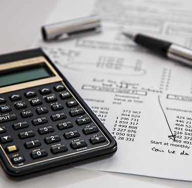 a calculator and pen on a paper with a pen