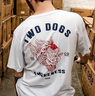 a man in a white shirt is standing in a warehouse
