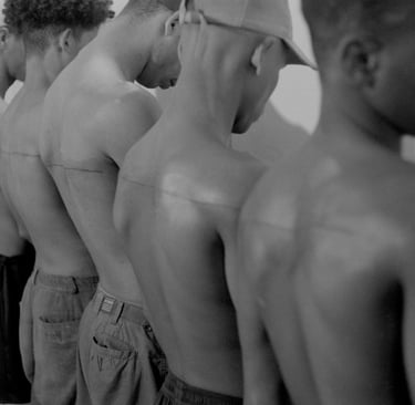 Santiago Sierra – 160 cm Line Tattooed on 4 People (2000)