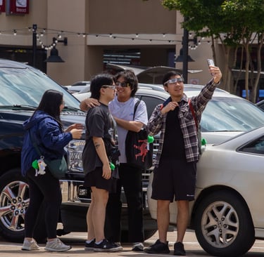 Four North Texas students play around and hang out in the 85C Bakery Cafe parking lot. Photo by Taylor Pleasant