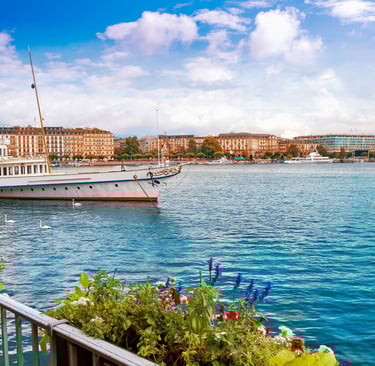 an image of a lake with nice water, houses and boats