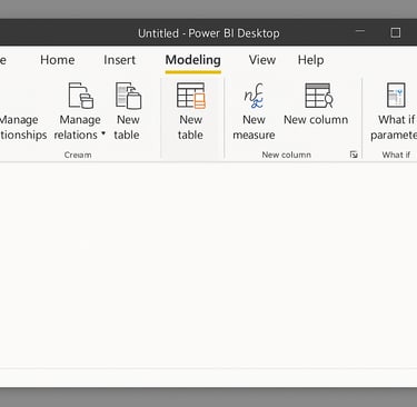 Power BI Desktop Modeling tab ribbon with the New Table icon highlighted, against a blank report canvas."