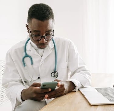 a male doctor in a white coat and a laptop