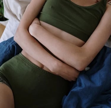 a woman in a green top and a white bottom