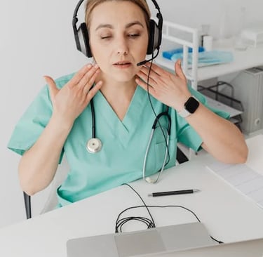 a woman in a green scrub suit and headphones