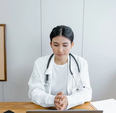 a woman in a white lab coat and a stethrobe