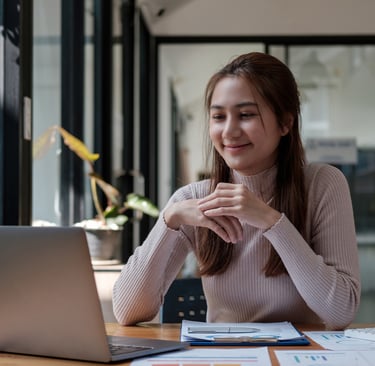 "Female therapist conducting an online consultation from a modern office setting via laptop"