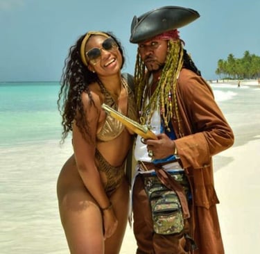 a man and woman in pirate costume on a beach saona island and pirata