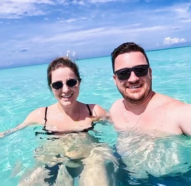 a man and woman in bikinis in the ocean piscina natural on saona island